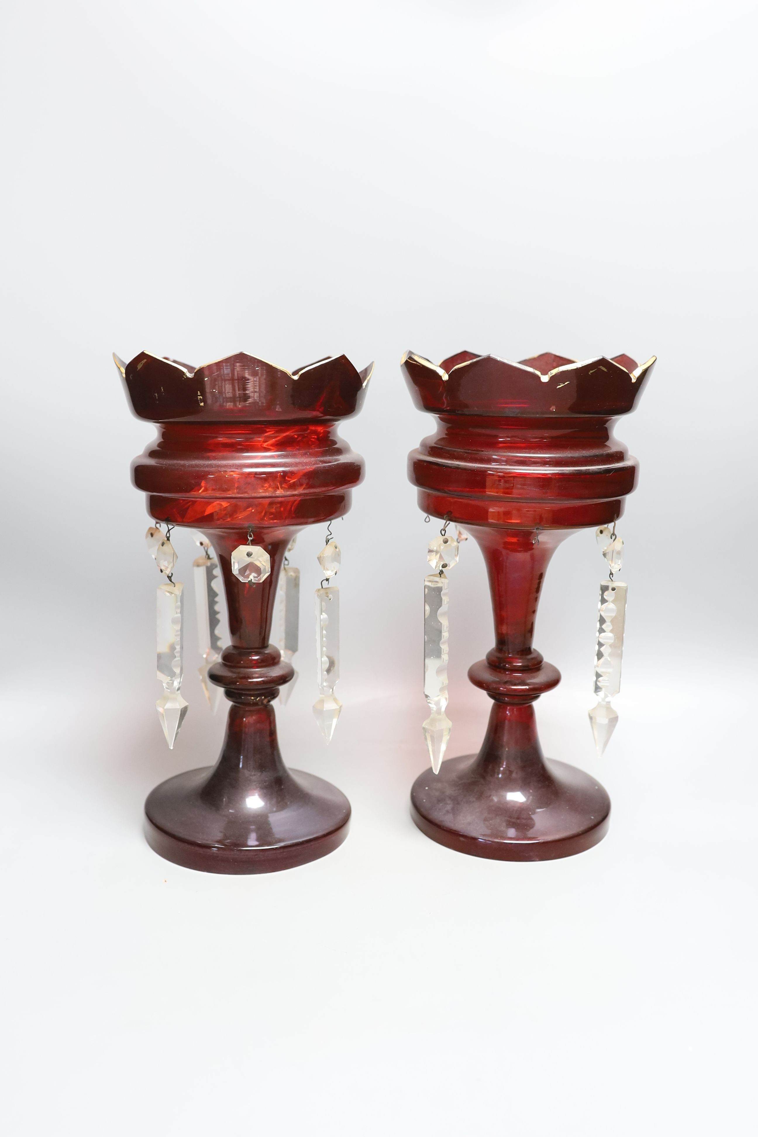 A pair of late 19th century ruby glass lustres, 30cm tall, cranberry jug, Bohemian vase and one other (5)